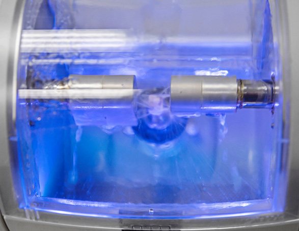 Close-up of CEREC machine creating a dental crown