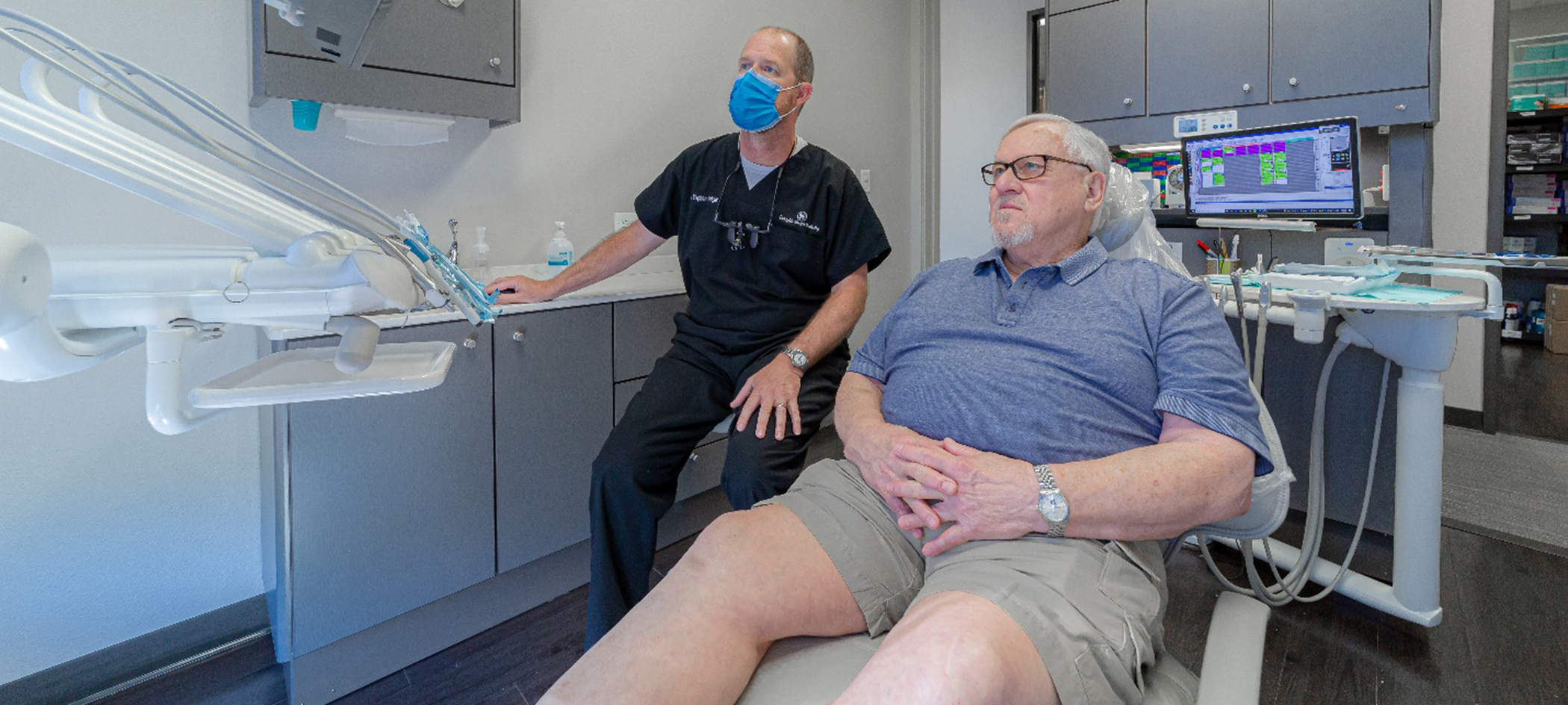 Dentist and patient looking at monitor together