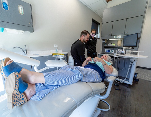 Dentist and patient talking during consultation at Wright Naeger Dentistry