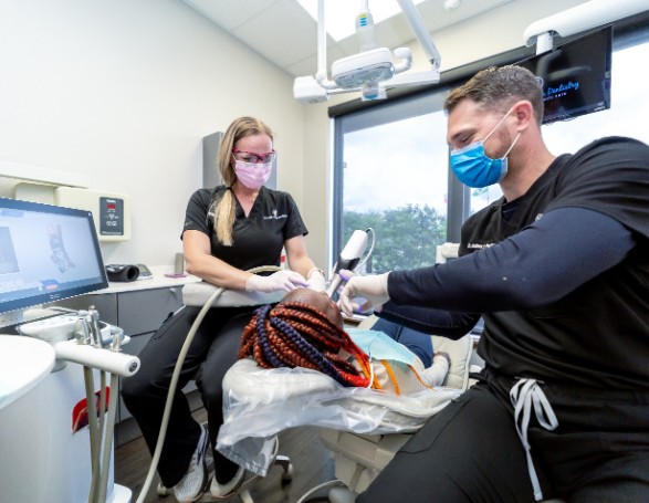 Team at Wright Naeger Dentistry working on patient