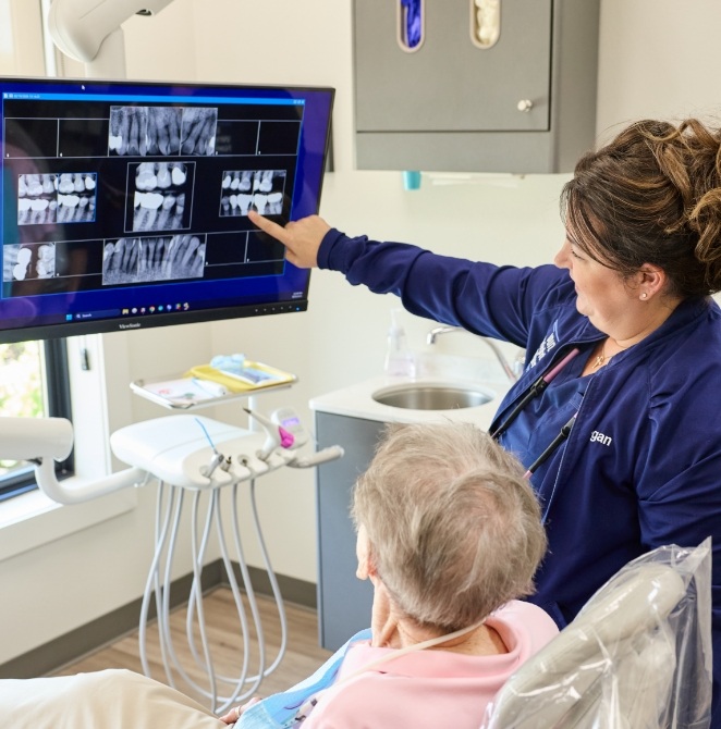 Doctor Wright wearing dental binoculars while treating a patient