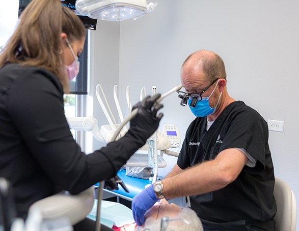 Dr. Wright and team member carefully working on patient