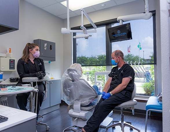 Dr. Wright and team member speaking with patient