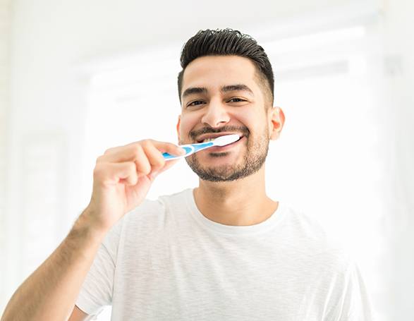 Bearded man brushing his teeth