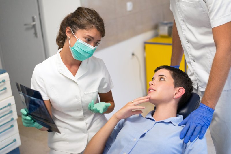 Patient discussing dental implants with dentist